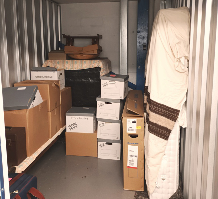 A medium sized storage unit filled with a students belongings 